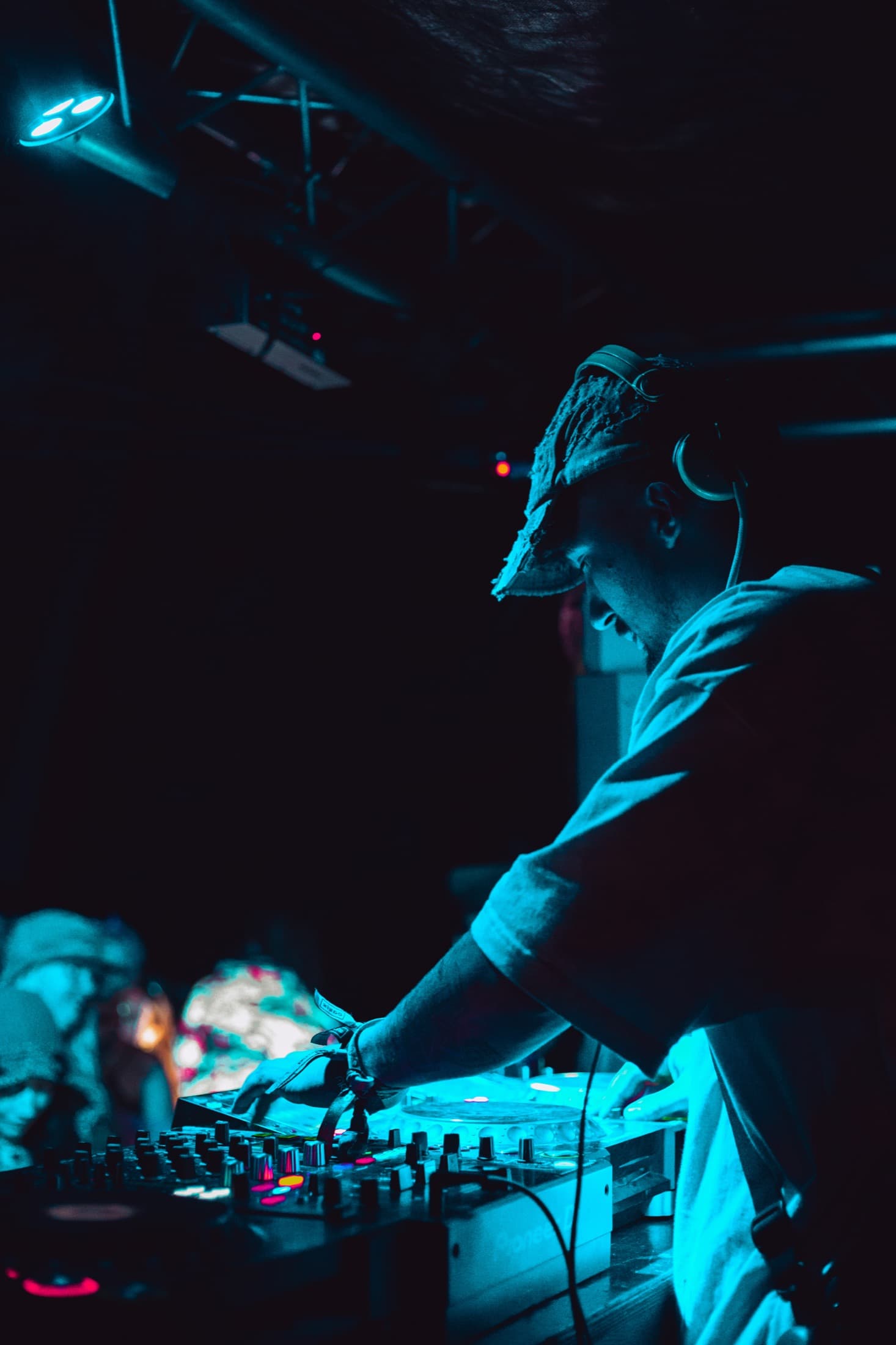 DJ performing under blue night lighting