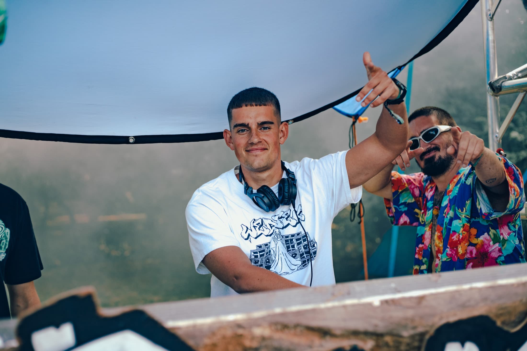 DJs performing on an outdoor festival stage