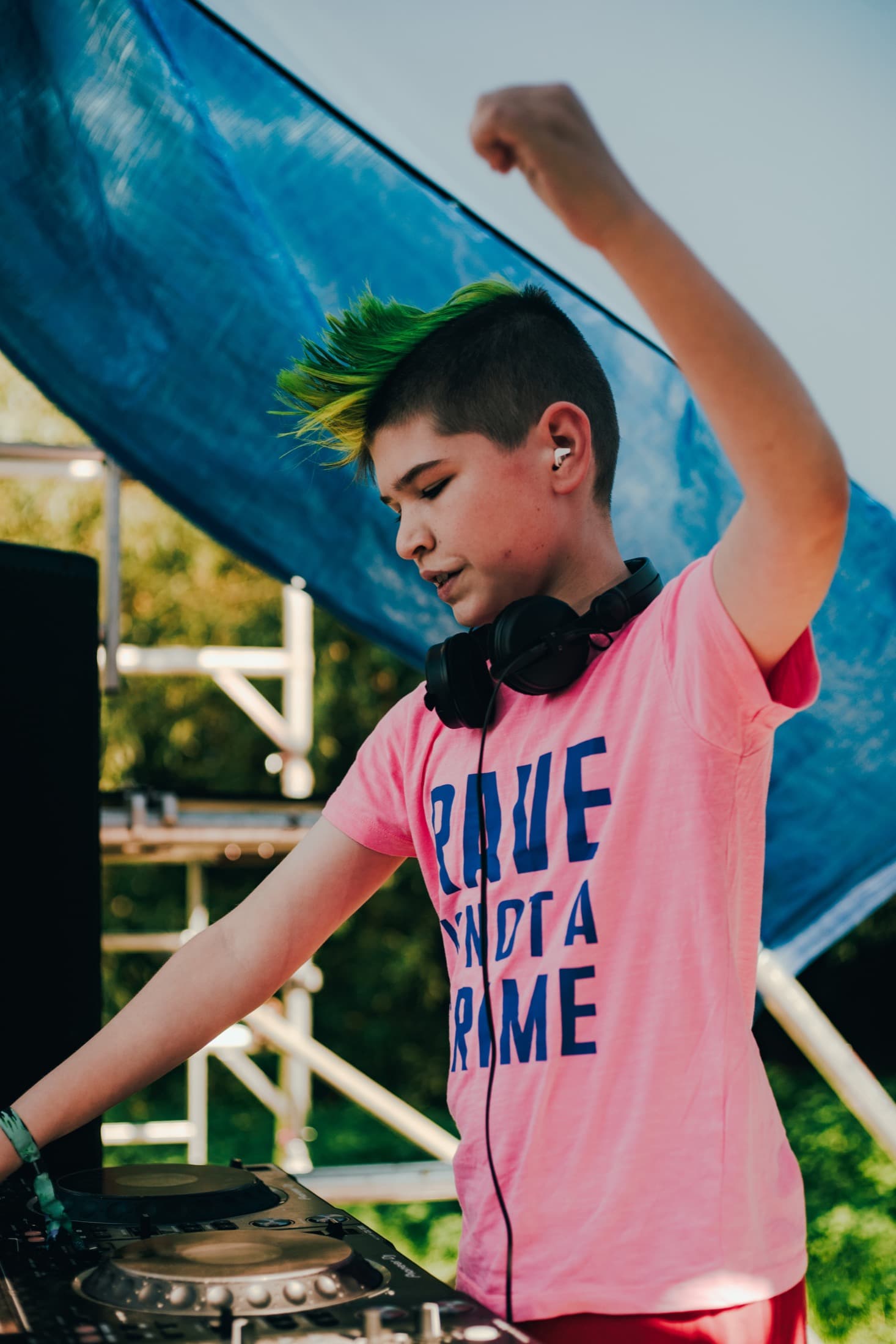 Young DJ performing on an outdoor festival stage